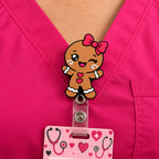 Gingerbread girl badge reel clipped to pink scrubs