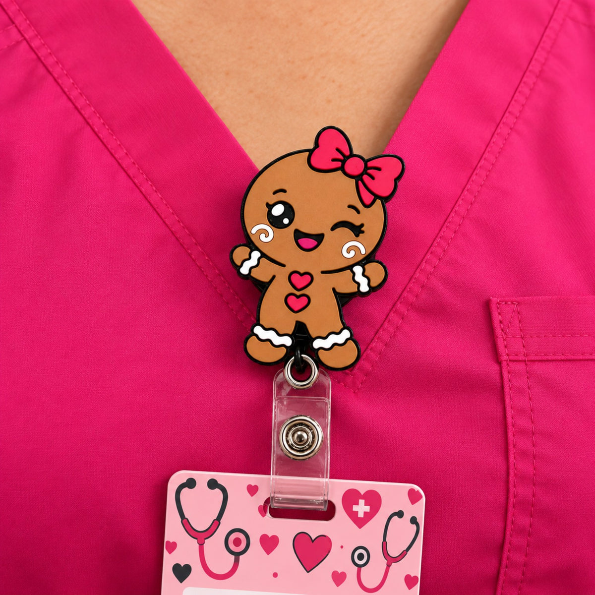 Gingerbread girl badge reel clipped to pink scrubs