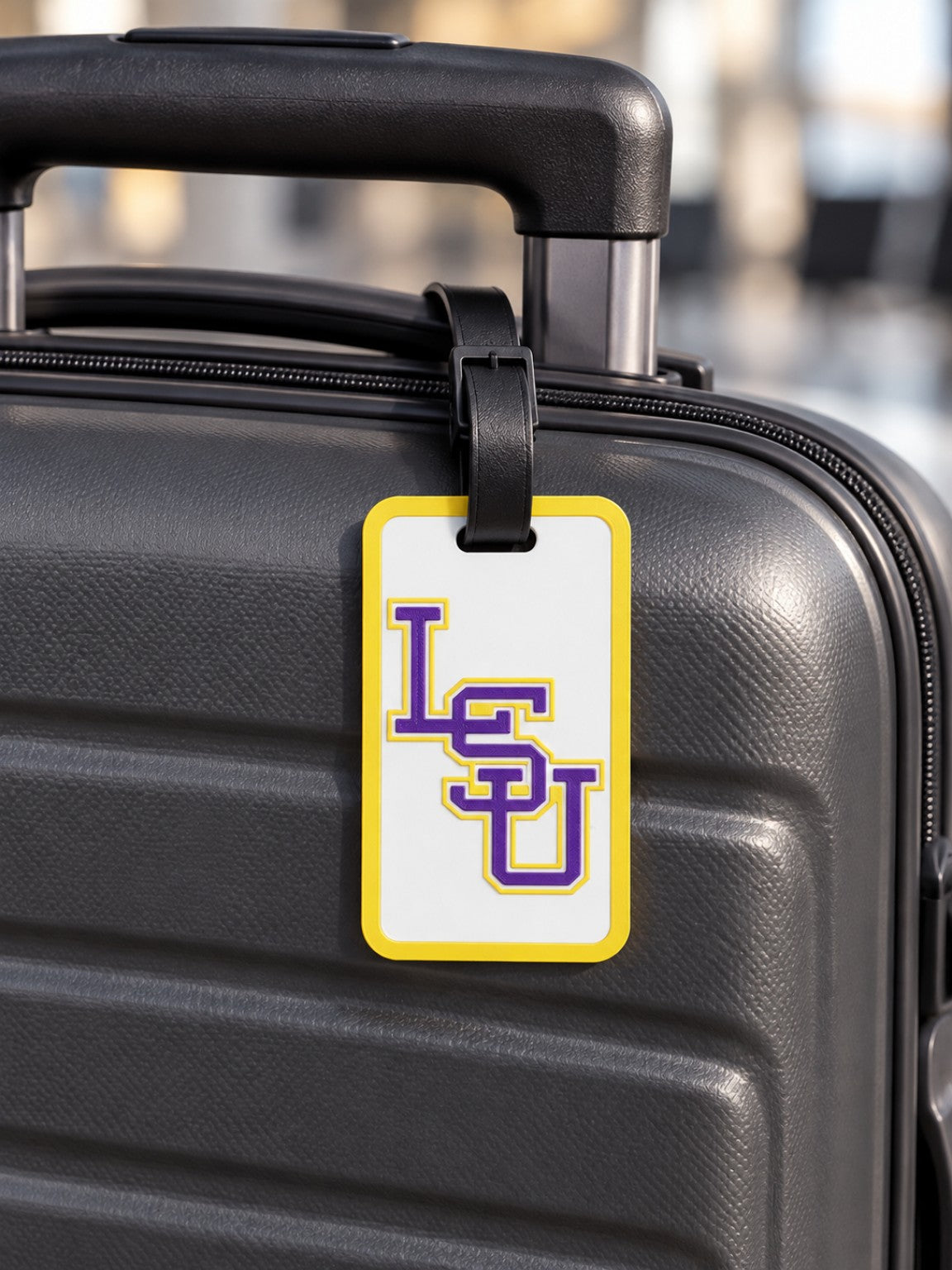 Purple and gold LSU letter design luggage tag on suitcase