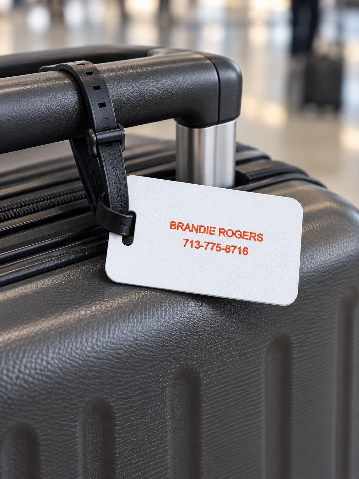 Back of luggage tag with personalized name and phone number