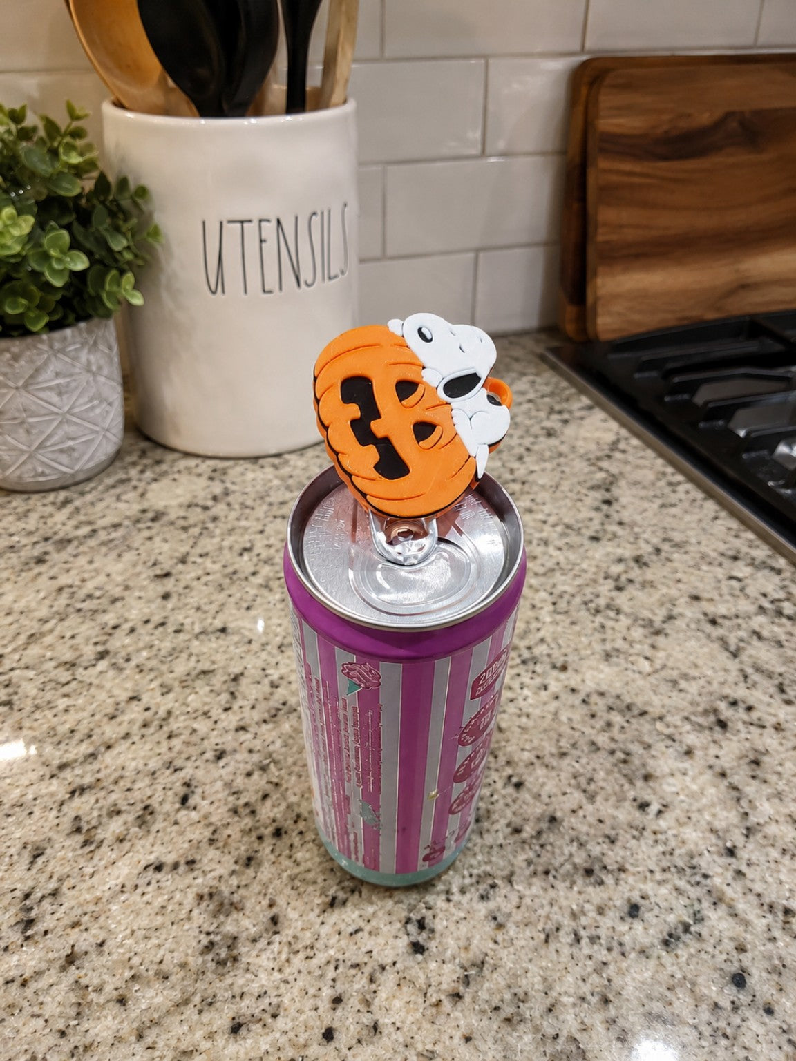 Orange and white 3D printed nail saver can opener on top of a beverage can