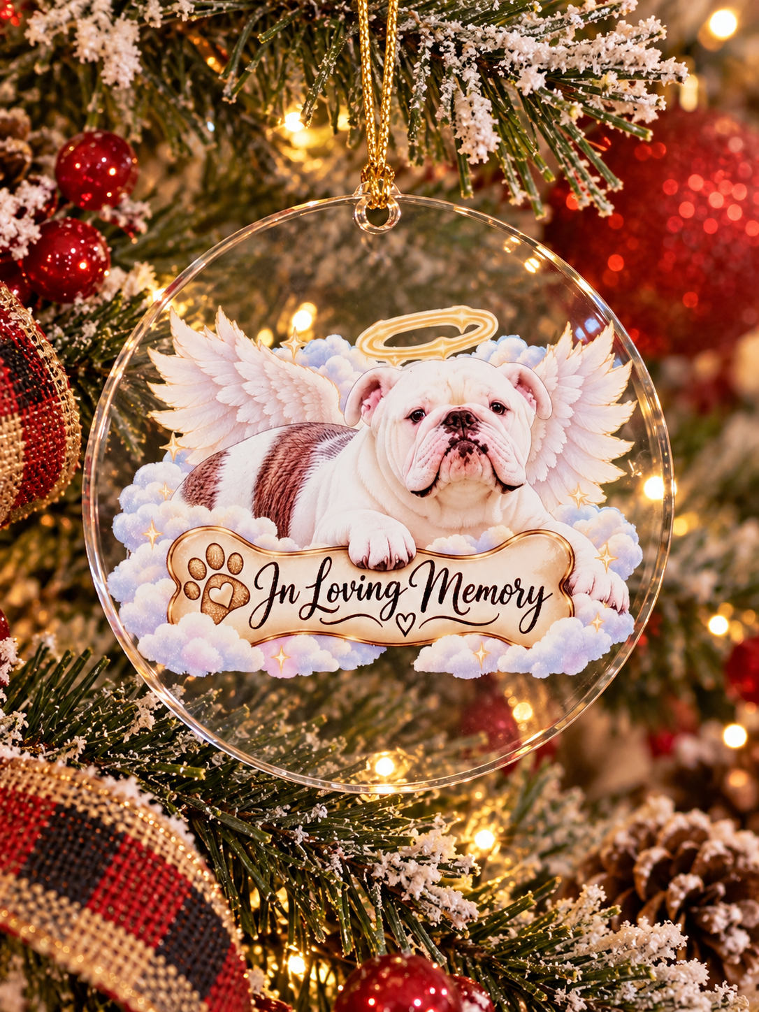 Personalized acrylic pet memorial ornament hanging on a Christmas tree, front view