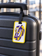 Purple and gold tiger design luggage tag on suitcase